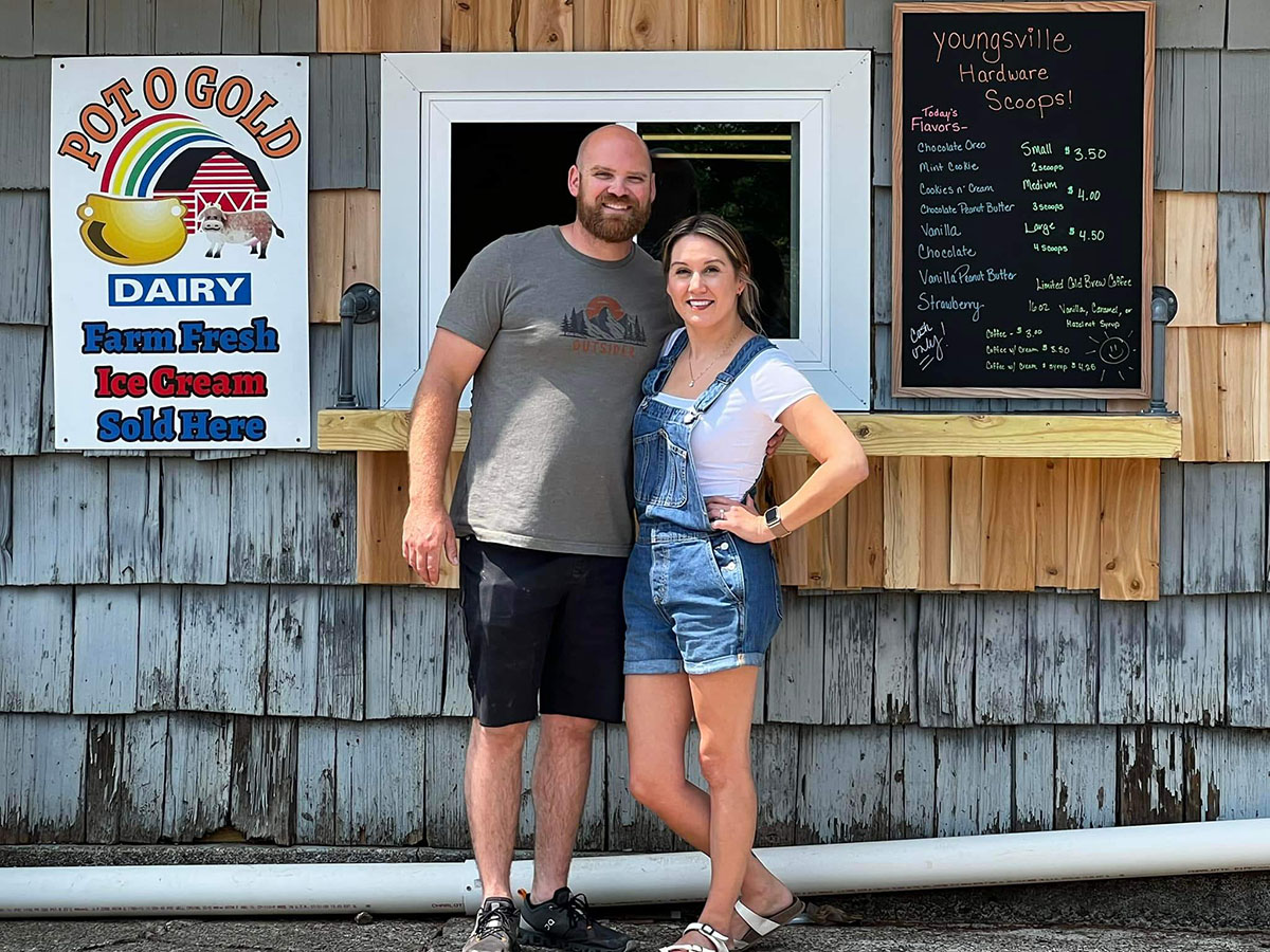 Owners Dustin and Callie Schwab in front of Scoops Ice Cream located in the parking lot at Youngsville Hardware