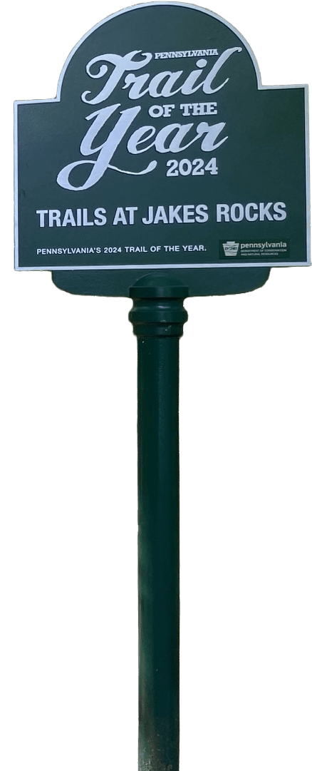 Official green Pennsylvania Trail of the Year 2024 sign for the Trails at Jakes Rocks in Warren County PA.