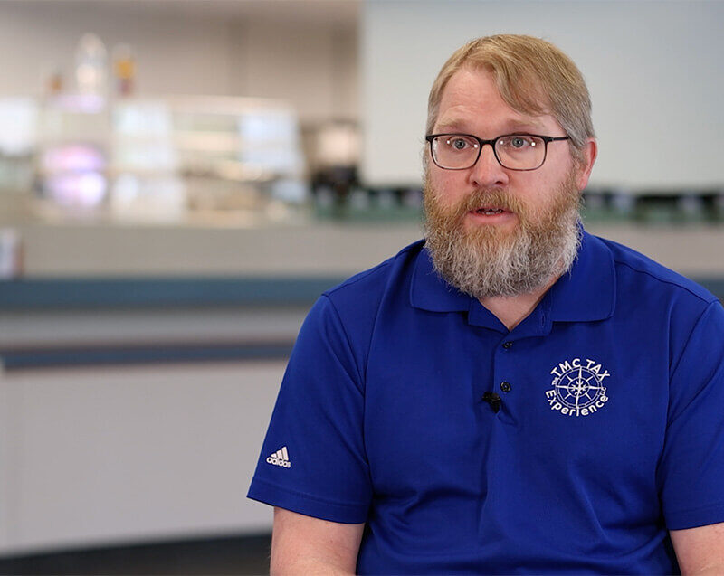 Troy Clawson wearing a blue TMC Tax Experience shirt in Youngsville, PA for the Warren County Citizen Spotlight video.