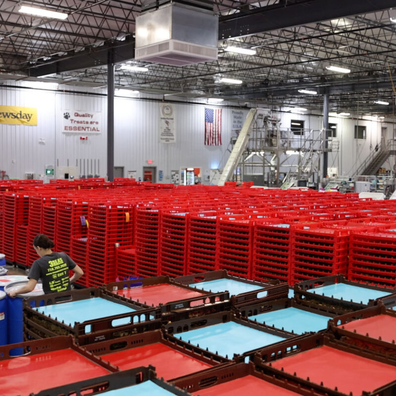Targeted PetCare manufacturing facility in Warren, Pennsylvania, showing production equipment, storage containers, and processing trays.
